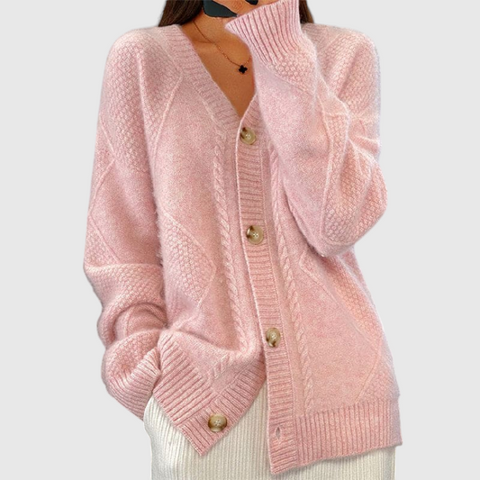 Frau trägt eine rosa Strickjacke mit Knopfleiste und Zopfmuster im Oversized-Schnitt._0